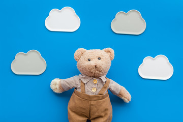 Handmade toys for newborn baby. Teddy bear. Blue background top view