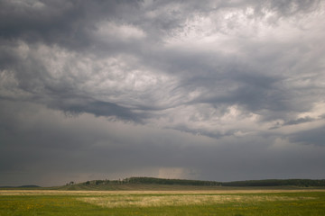 Fototapeta na wymiar Storm sky over a field in the countryside.