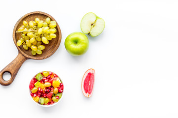 Healthy diet concept. Fruit salad near fresh fruits on white background top view space for text
