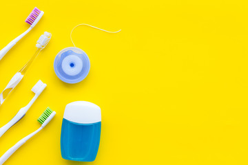 Tooth care with toothbrush, dental floss. Set of cleaning products for teeth on yellow background...