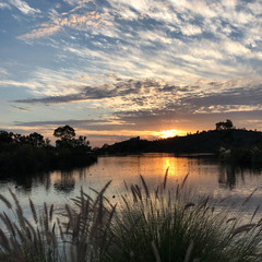 Fototapeta na wymiar Beautiful sunset over a quiet Lake Murray in San Diego California