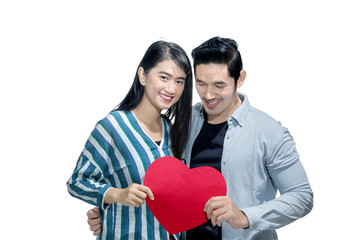 Happy asian couple holding red heart together