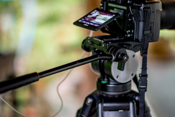 Camera is shooting video on natural background. It's a on-tripod.