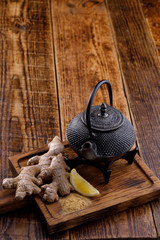 Cast iron kettle with a hot drink of ginger and lemon. Copy space.