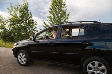 Obraz na płótnie Canvas Two girls in a car in a summer evening