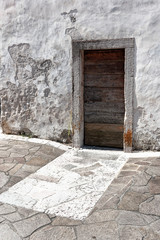 Fototapeta premium wooden door in an old stone house.