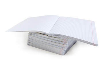 Open exercise book on a stack of other exercise books