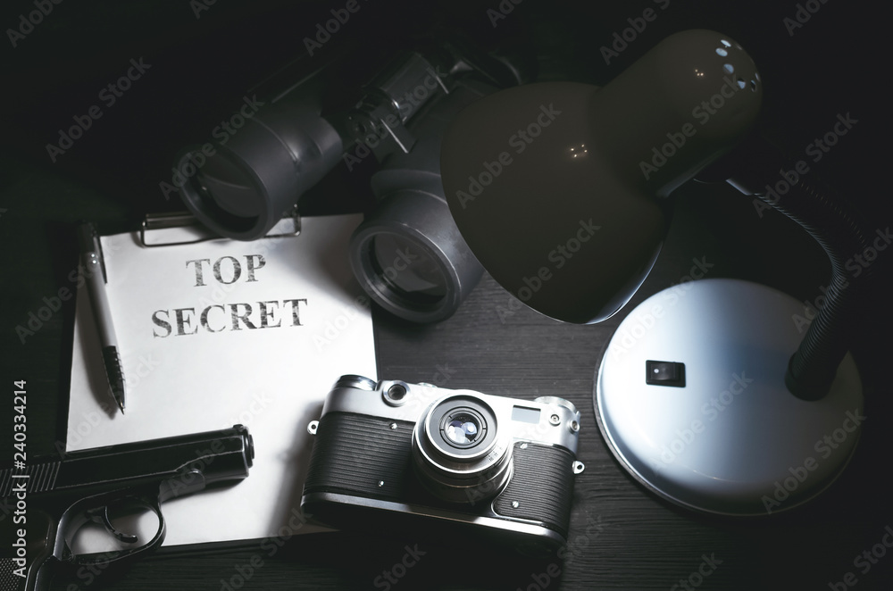 Wall mural top secret information data on the secret service agent table background. espionage concept.
