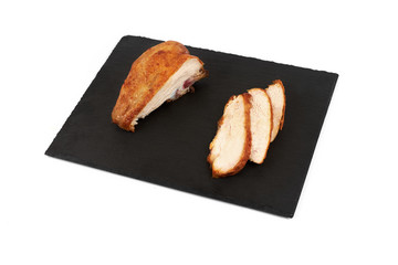 Grilled chicken fillets on slate plate isolated on white background