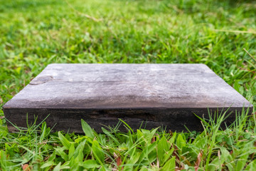 Fototapeta premium Empty wooden board on grass