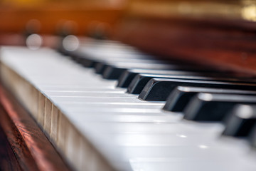 Closeup image of a vintage wooden grand piano