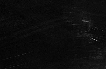 Old black stucco wall with white scratches and scuffs texture. textured grunge black board with...