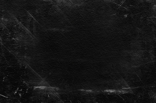Old black stucco wall with white scratches and scuffs texture. textured grunge black board with chalk