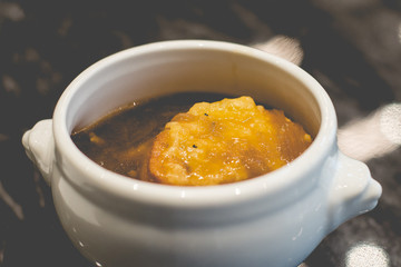 French Onion Soup with baguette and cheese on top