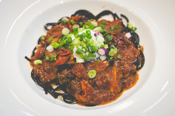 Buttered crab meat, squid ink pasta, spicy chilly crab sauce, poached egg