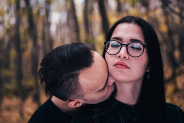 young man and woman in the autumn forest