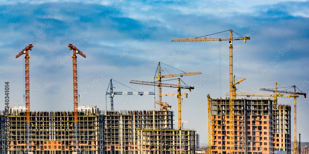 Wall mural construction of new residential buildings against the sky . the concept of the construction business