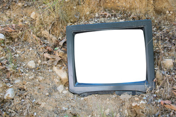 Vintage old television on the floor at garden park, classic TV -with blank white screen