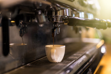 Coffee extraction from professional coffee machine. Coffee shop.