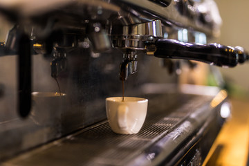 Espresso coffee machine working with bar interior background