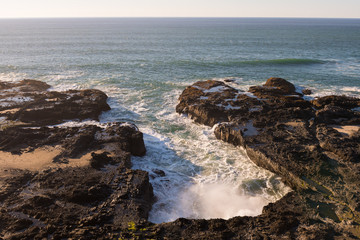 Waves in a water inlet breaks against the rocks in Cape Perpetua Scenic Area