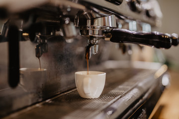 Coffee espresso machine. Espresso machine making coffee, golden espresso flowing.