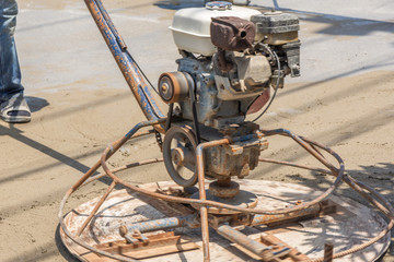 Workers are using concrete polishing machines for cement after Pouring ready-mixed concrete on...