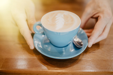Close-up of man hands preparing coffee in blue cup