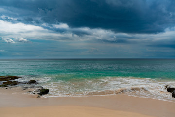 Turquoise ocean water with dramatic sky 