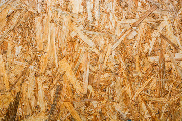 Close up sawdust texture. Surface of plywood. Pressed tree chips.