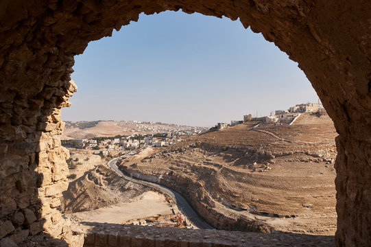 View of the Royal road through the arched window of the Crusader Castle or Kerak Castle. Al-Karak, Jordan, Middle East
