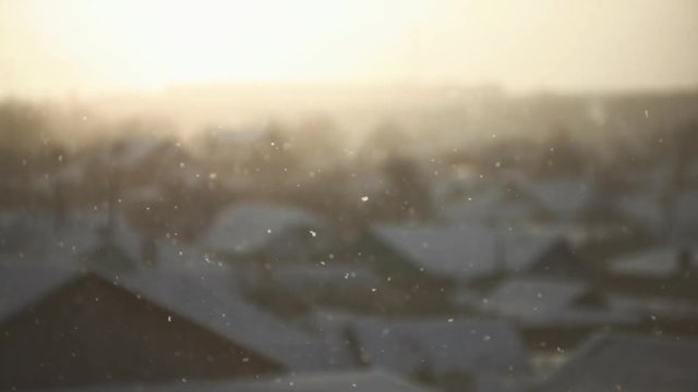 A snow scene of urban landscape covered in white snow in freezing weather, blurred background rooftops house