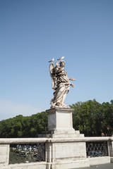 Marble statue by Bernini on the Bridge of Angels, Rome, Italy, with two seagulls sitting on its head