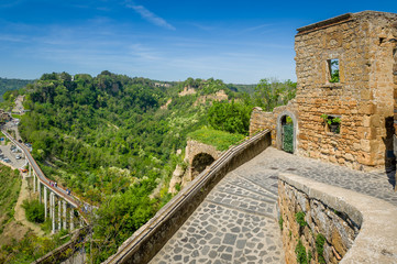 Fototapeta na wymiar Bridge view and walls of Civita di Bagnoregio old town.
