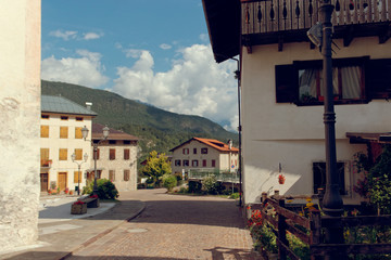 Fototapeta premium Caralte di Cadore, Italy - August 12, 2018: Beautiful old and modern buildings in a mountain village.