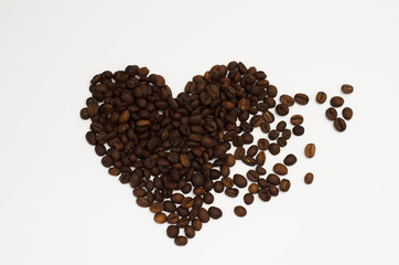 roasted coffee beans lie on a white background in the form of a heart
