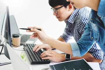 Asian team Outsource Developer Looking Screen Programming Code Working with Laptop Computer...