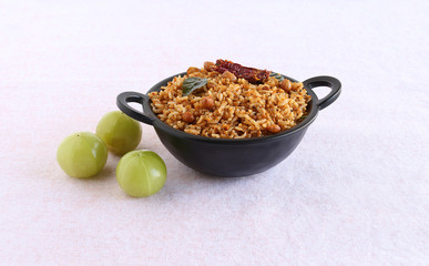Puliyogare, a traditional and popular south Indian vegetarian rice cuisine, with amla or Indian gooseberry as a main ingredient.