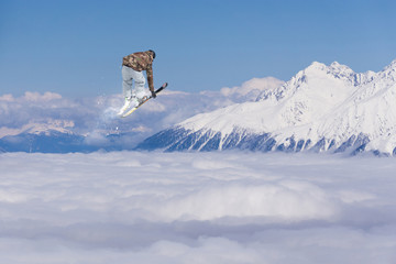 Naklejka na ściany i meble Flying skier on snowy mountains. Extreme winter sport, alpine ski. Copy space.
