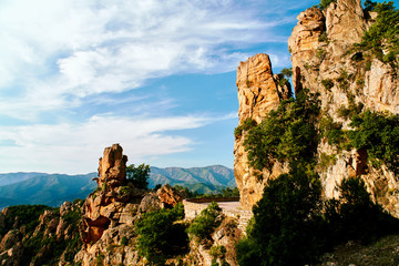 Curved road through the Calanques de Piana in Corsica on sunny afternoon