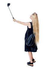 back view of standing young beautiful  girl with tablet computer in the hands .