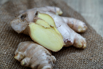 Ginger root sliced on wooden table