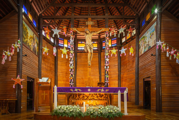 Inside old wooden Catholic cathedral church during decoration celebration of Christmas festive...