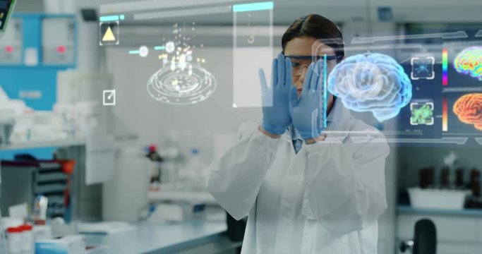 Portrait of futuristic researcher using the augmented reality screen with hologram graphics for viewing results of his research in laboratory. Shot in 8K. Concept of futuristic medicine and science