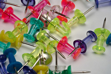  scattered thumbtacks photographed closely