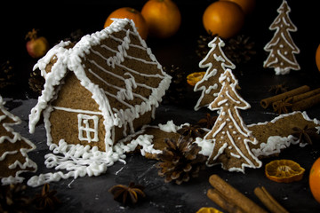 Gingerbread house on black night background, ginger cookies christmas dark photo
