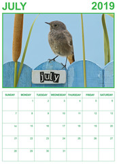 July 2019 calendar on english with a bird perched on a July decorated fence, portrait orientation