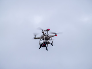 A drone in motion flying in the cloudy sky