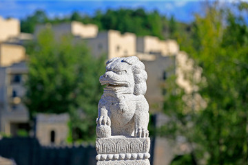 A stone lion on a stone bridge in ancient China