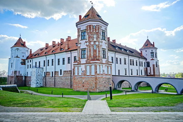 A beautiful ancient medieval castle with a red brick fortress wall